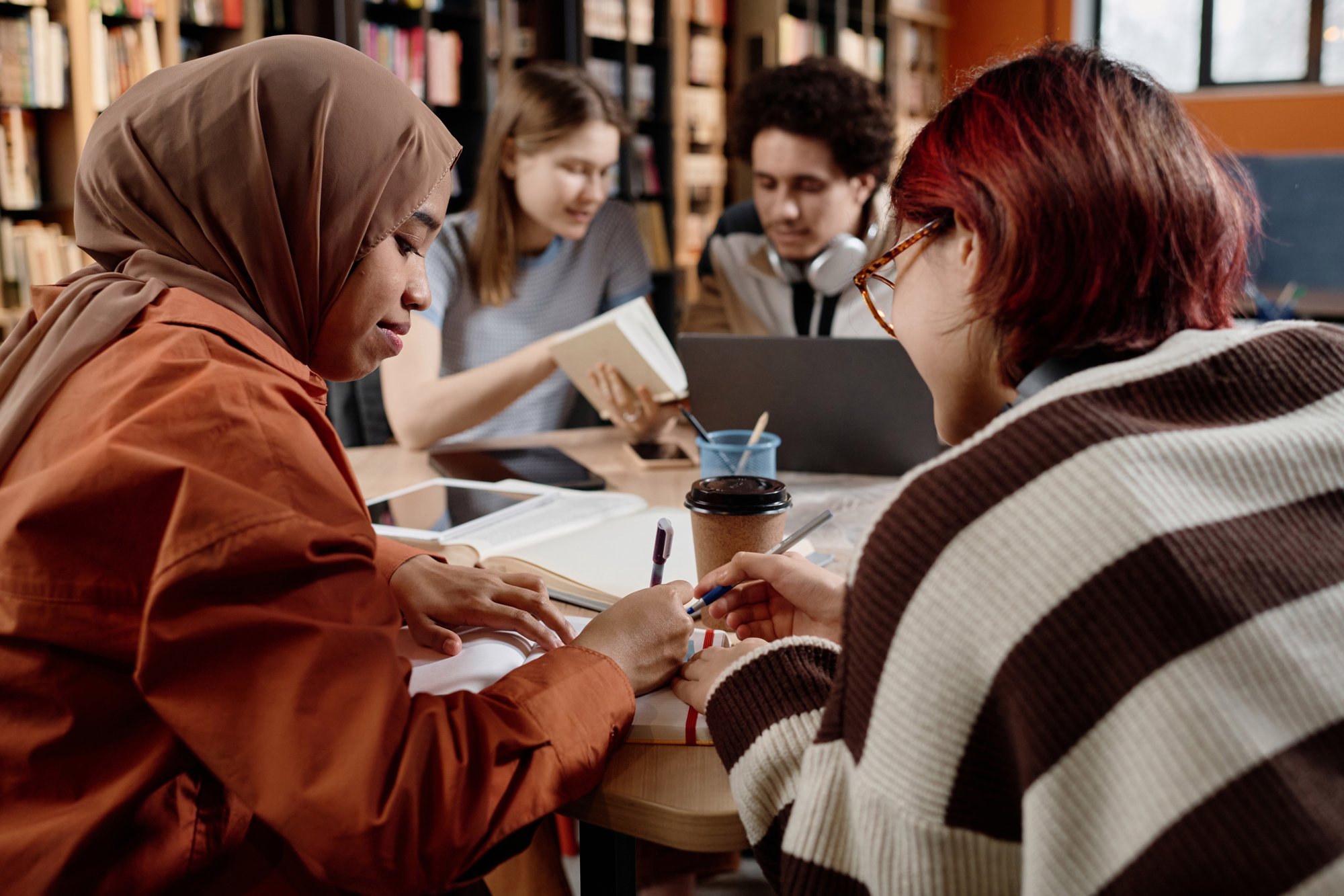 two-girls-studying-in-library-2024-05-22-16-31-09-utc